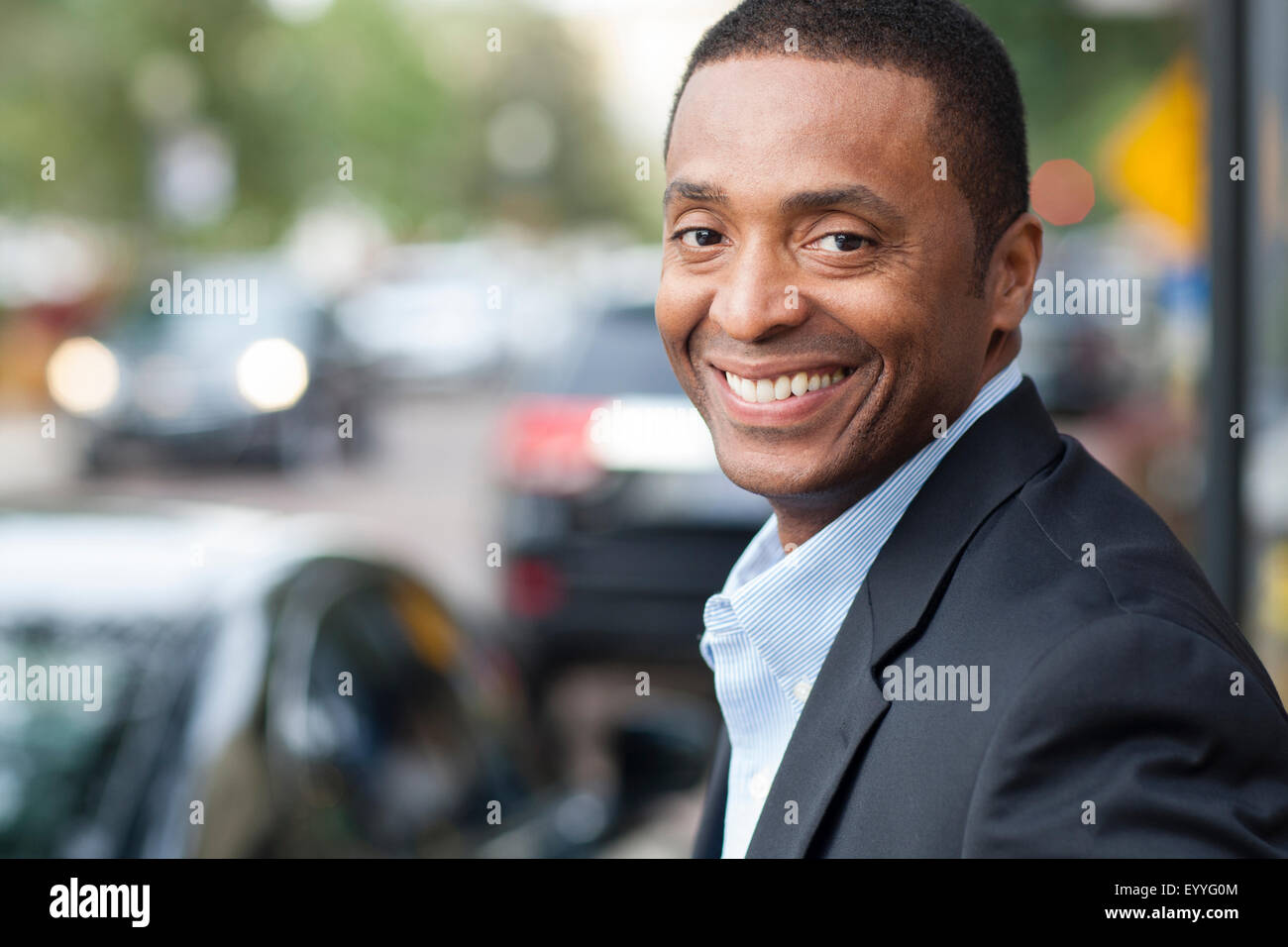 Black businessman smiling in city Stock Photo