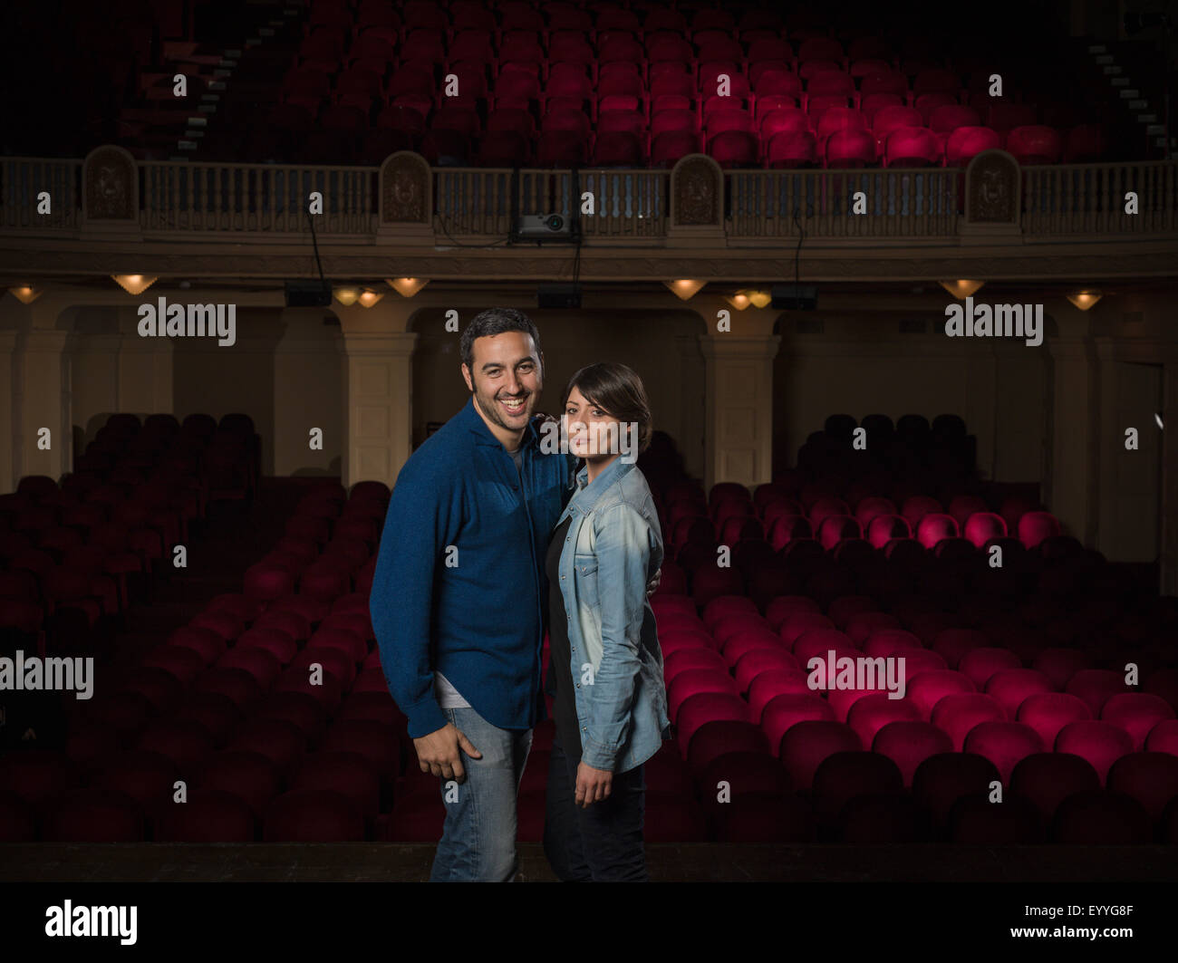 Caucasian couple standing in movie theater Stock Photo