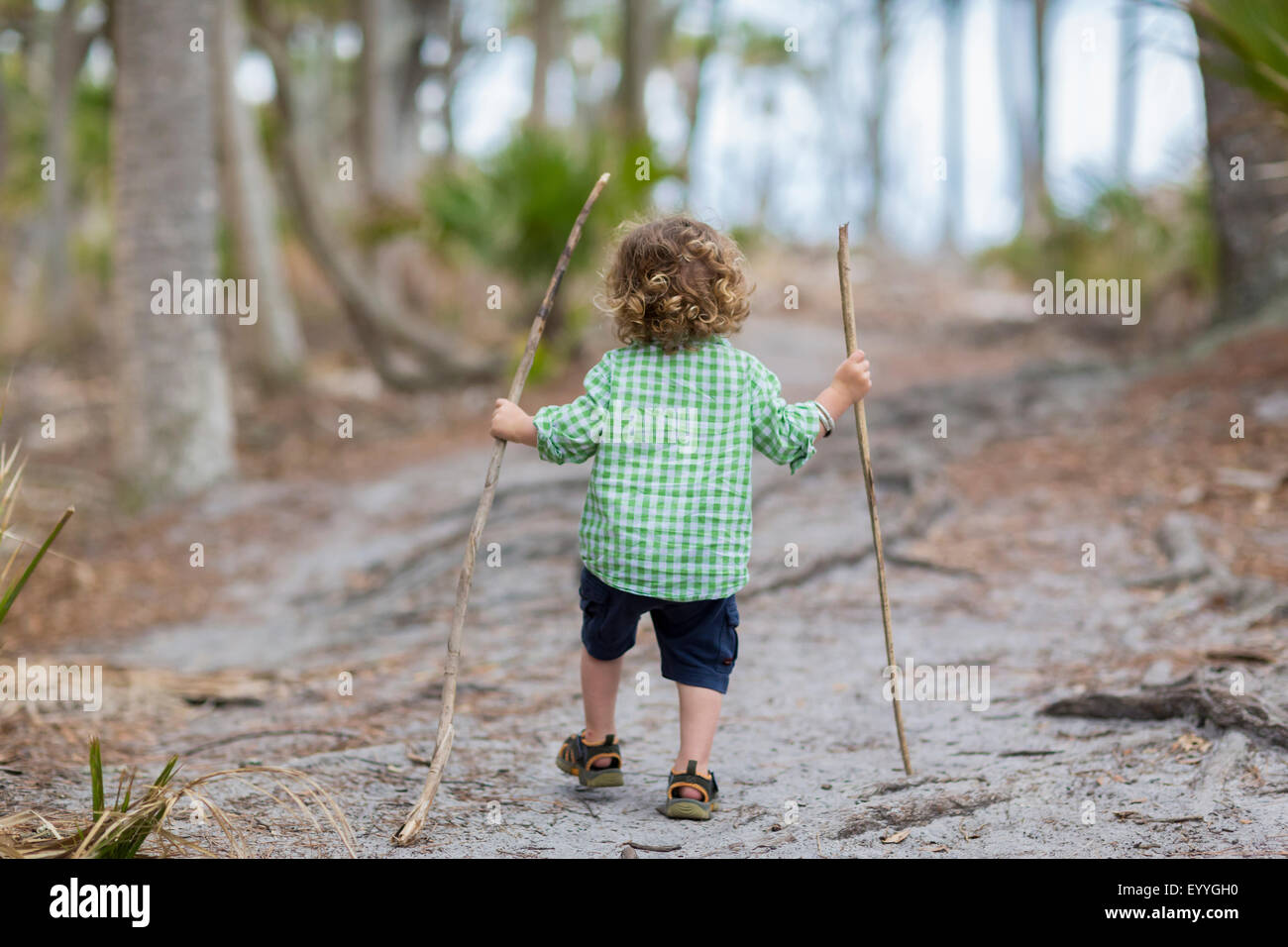 Caucasian baby boy walking on dirt path Stock Photo