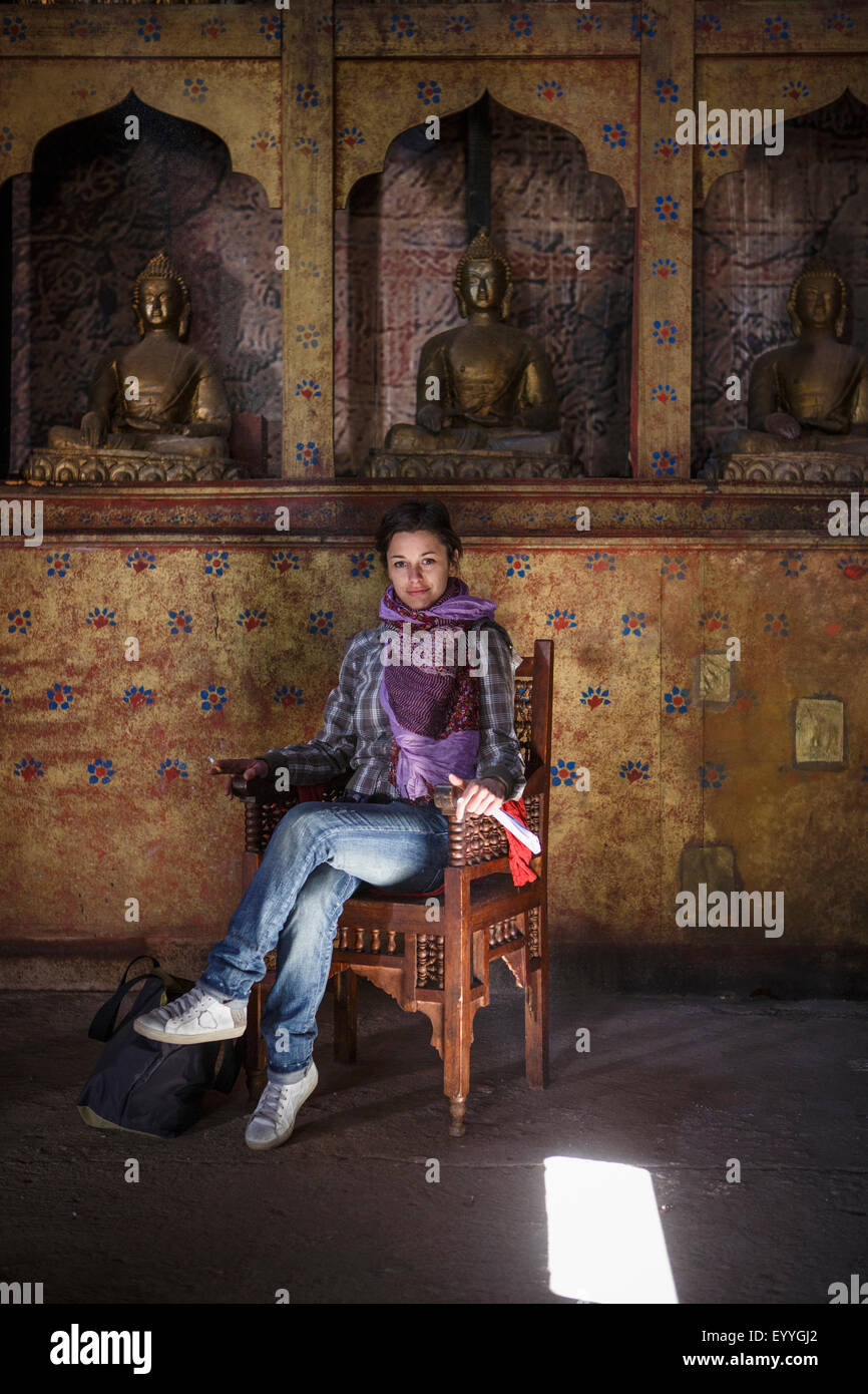 Caucasian woman sitting in chair in temple Stock Photo