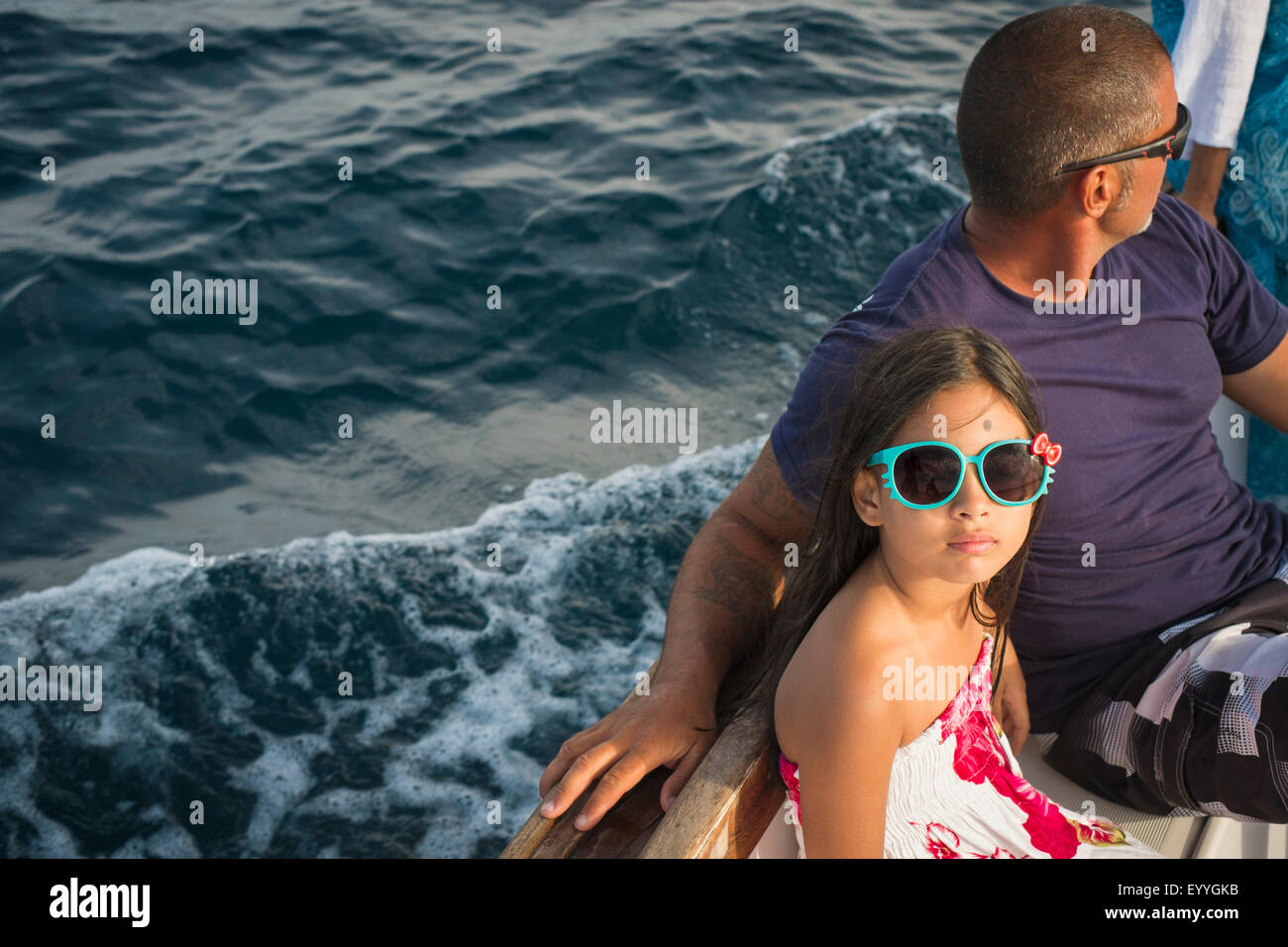 Father and daughter sitting on boat Stock Photo