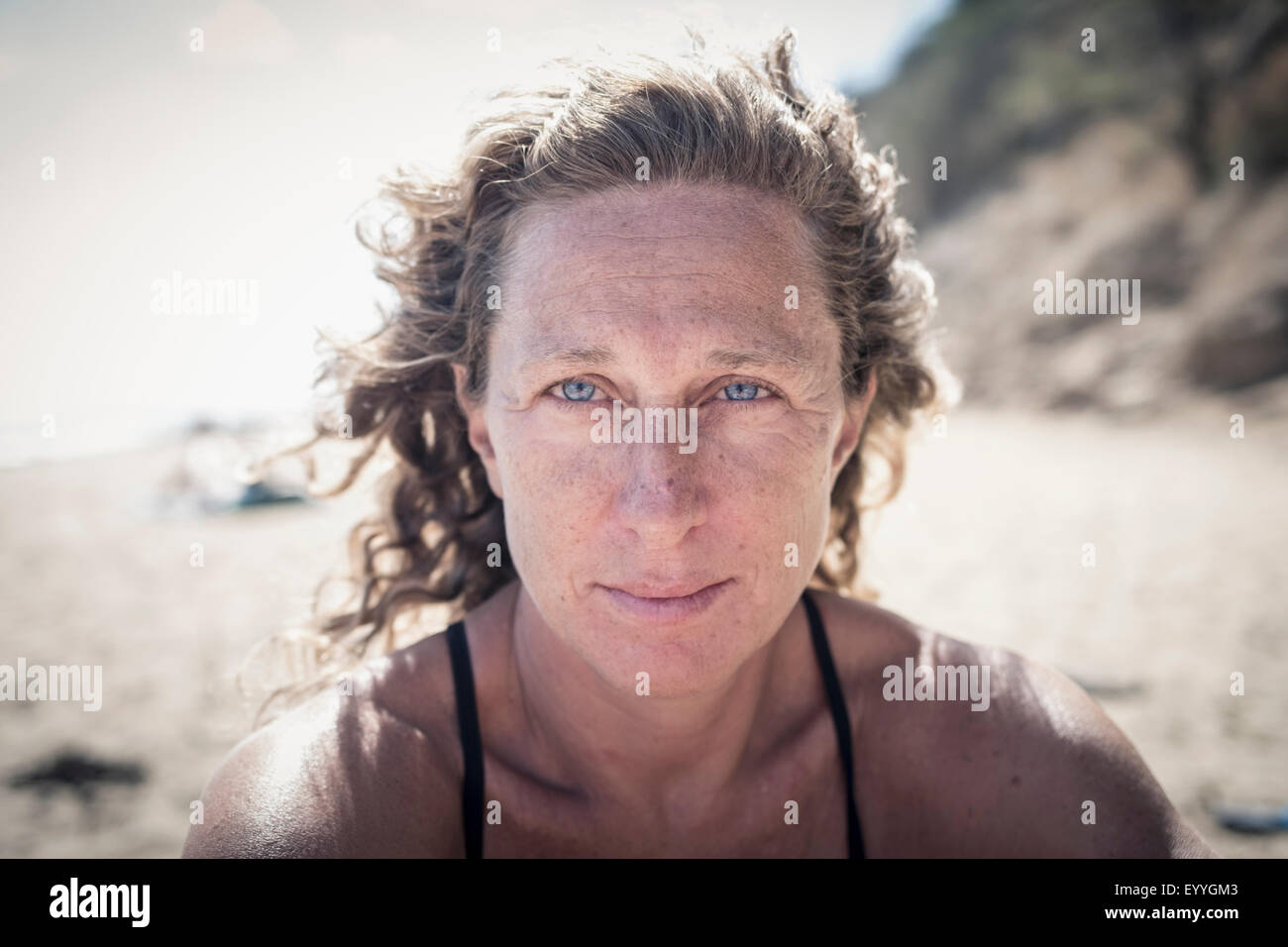 Serious Caucasian woman on beach Stock Photo