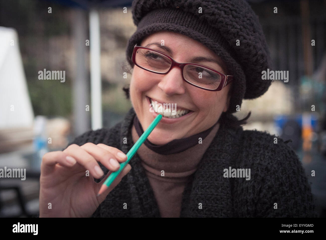 Close up of smiling Caucasian woman holding pencil Stock Photo
