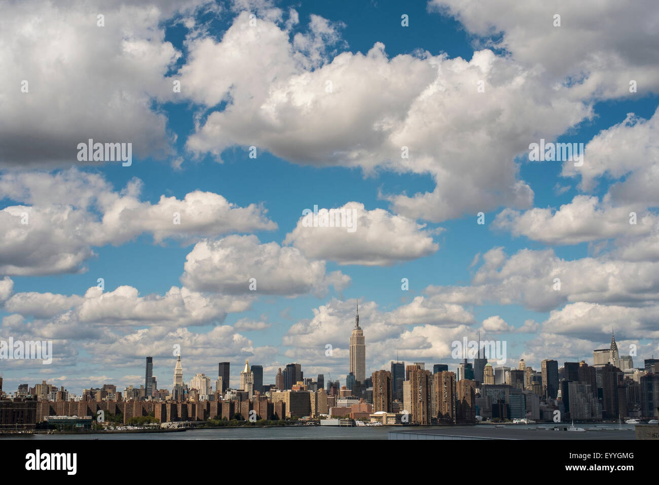 New York City skyline under cloudy blue sky, New York, United States Stock Photo