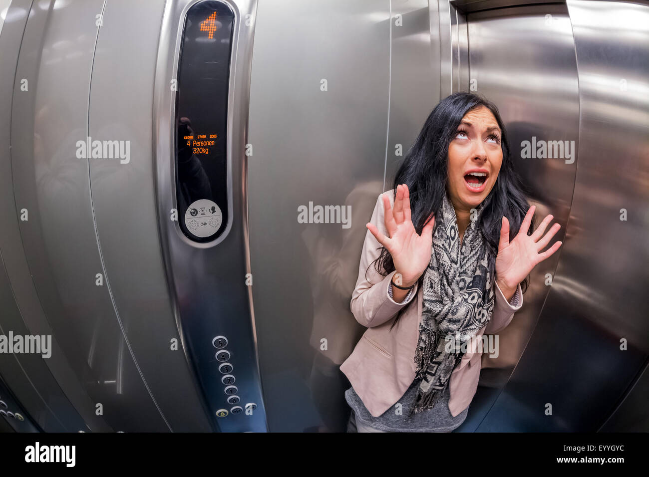 woman with claustrophobia in an elevator, Austria, Vienna Stock Photo