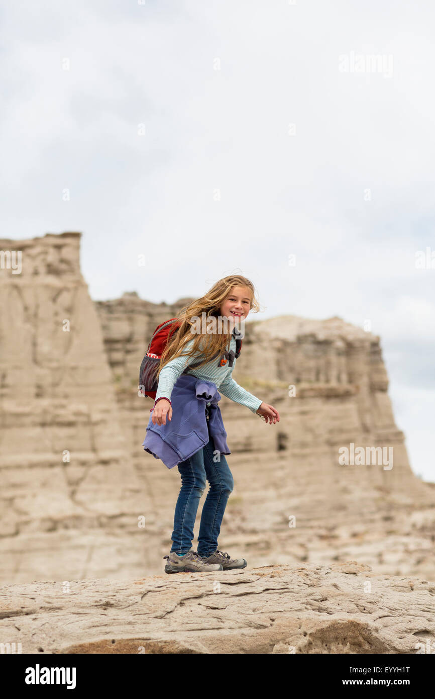Caucasian girl standing on desert rock formations Stock Photo