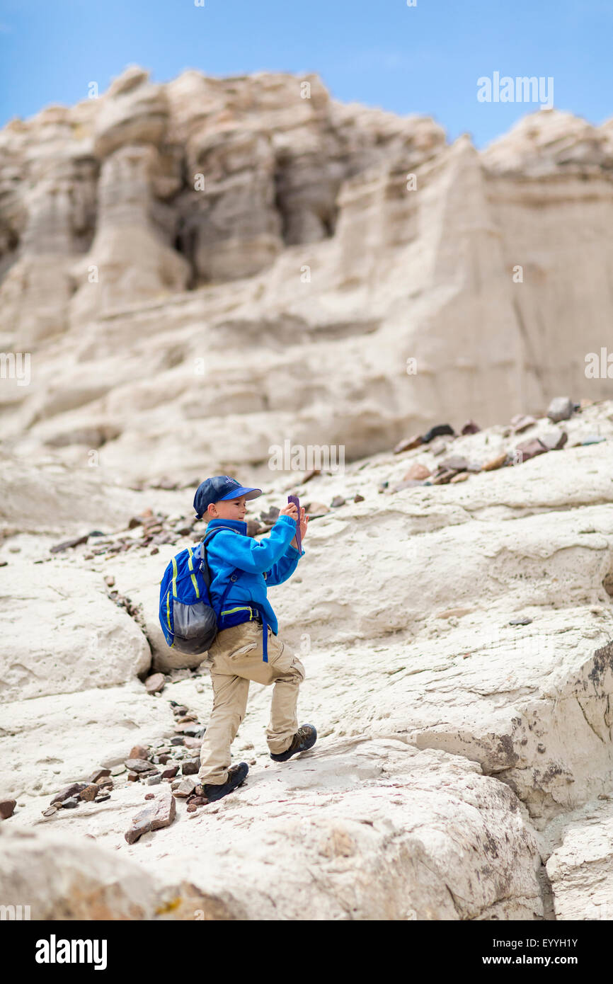 Boy photographing desert rock formations Stock Photo
