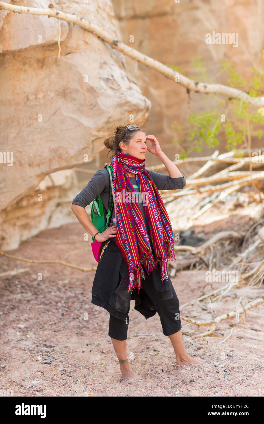 Mixed race hiker exploring desert rock formations barefoot Stock Photo