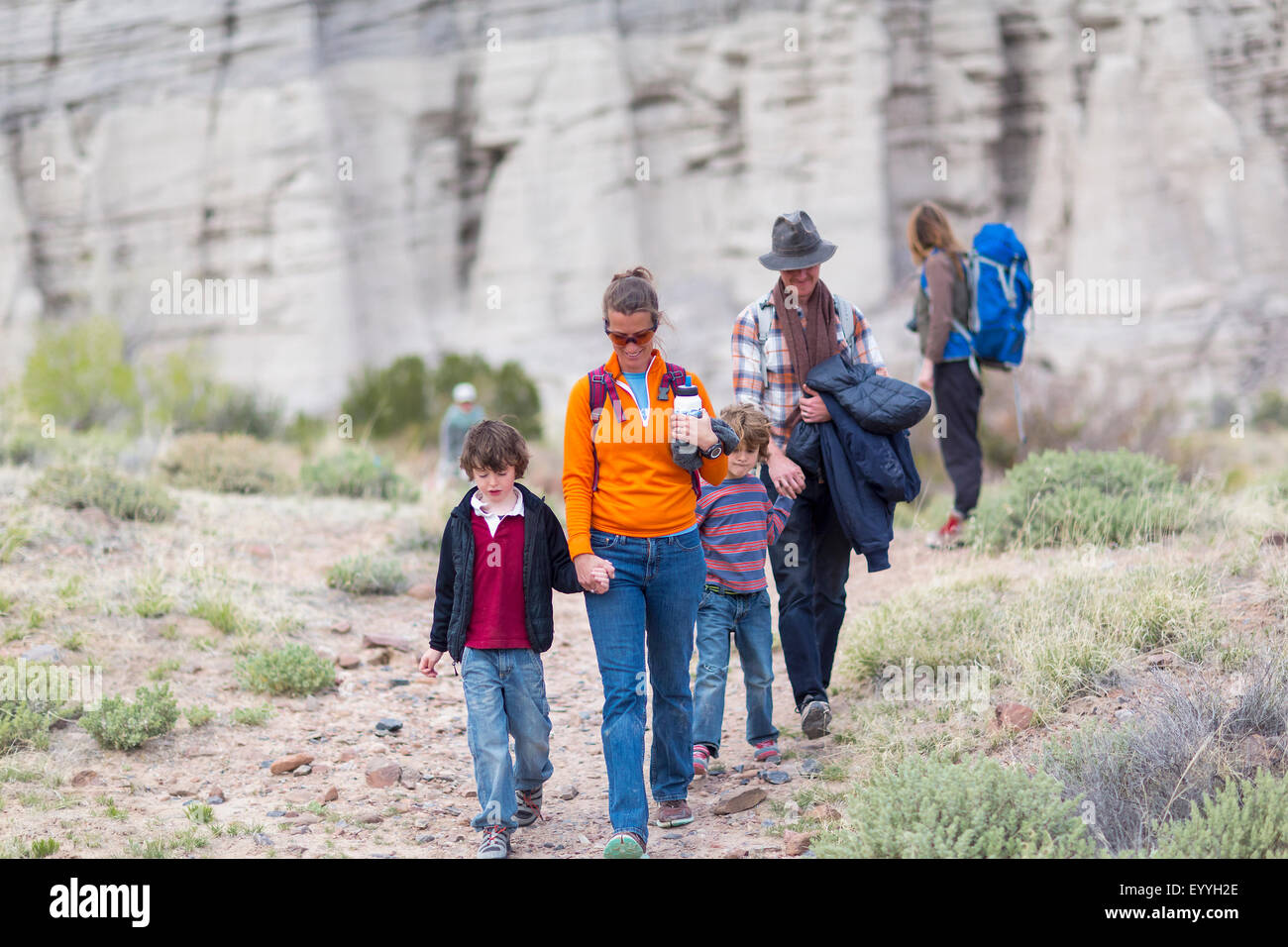 Family hiking on dirt path Stock Photo
