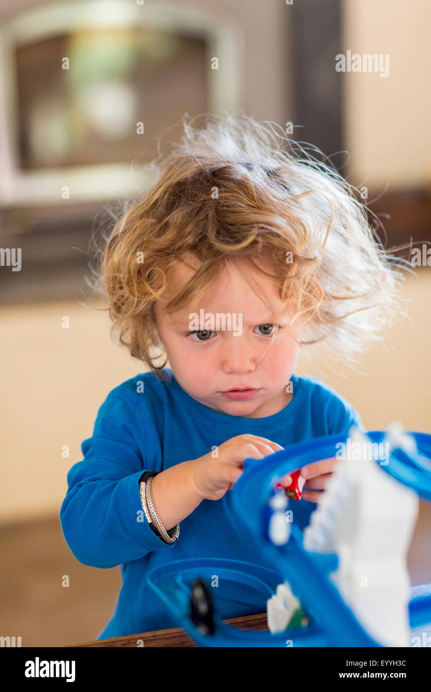 Caucasian baby boy playing with toy in living room Stock Photo