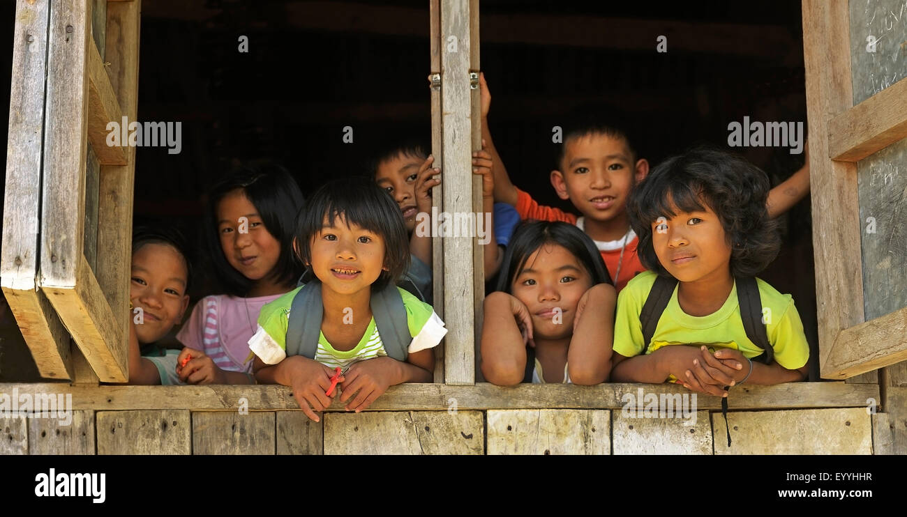 girls and boys of the Ifugao people looking out of a window, Philippines, Luzon, Patpat Stock Photo