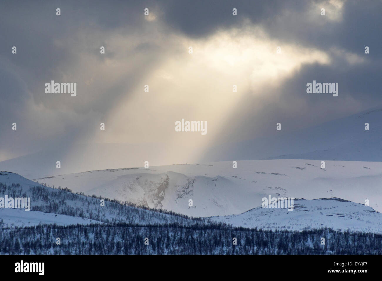 sunrays from hole in clouds, Norway, Troms, Kvaloeya, Tromsoe Stock Photo