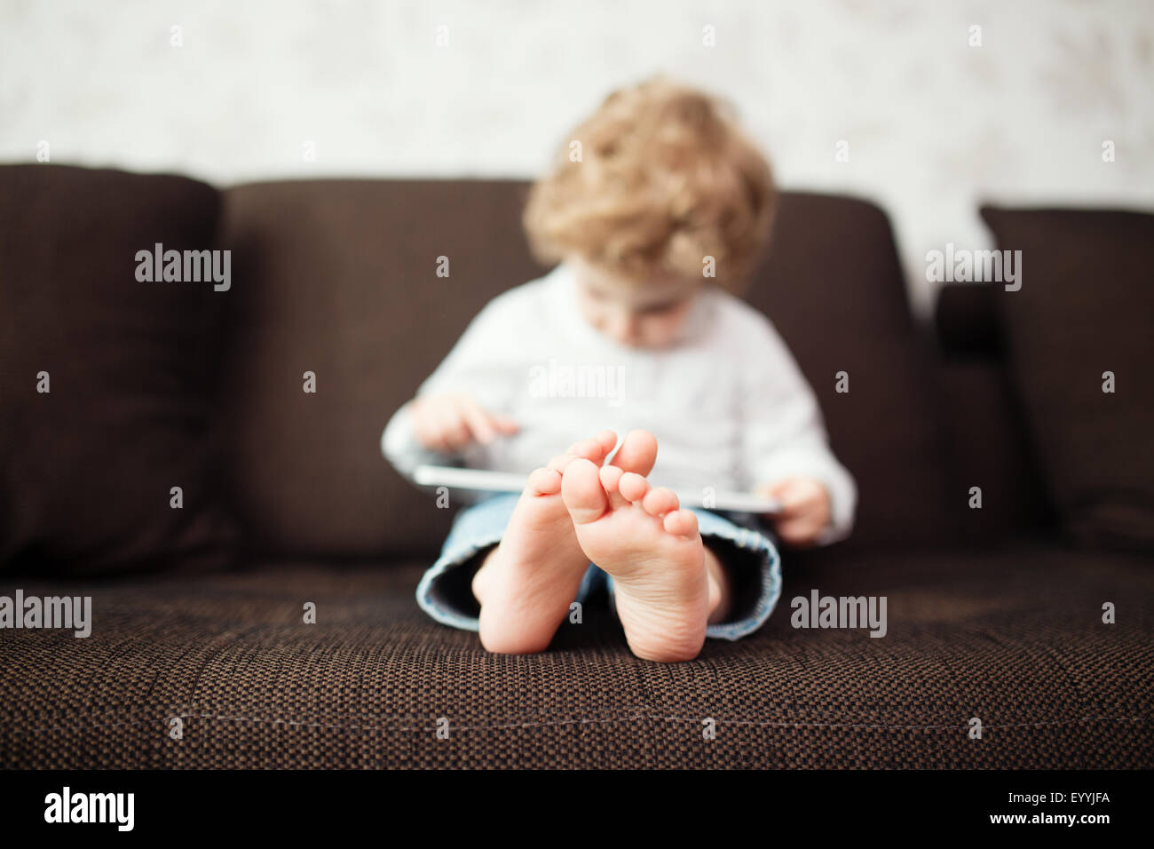 Little boy using tablet computer, indoor Stock Photo - Alamy