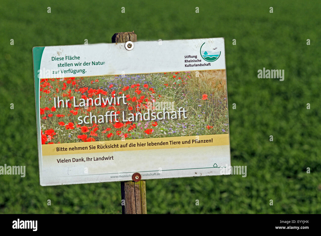 sign labeled 'Ihr Landwirt schafft Landschaft' in front of unused agricultural land, Germany Stock Photo