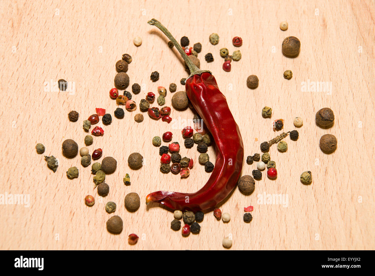 Chili pepper and mix the grains are on a wooden surface Stock Photo