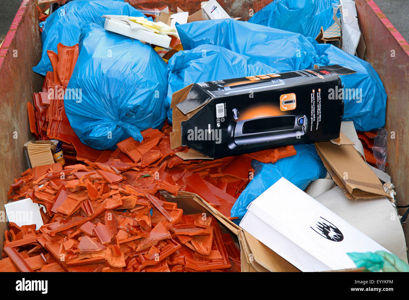 broken roof tiles and garbage in a garbage container, Germany Stock Photo
