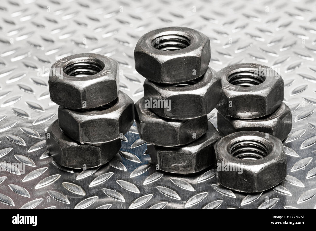 Metric thread Nuts arranged in stacks. Stock Photo