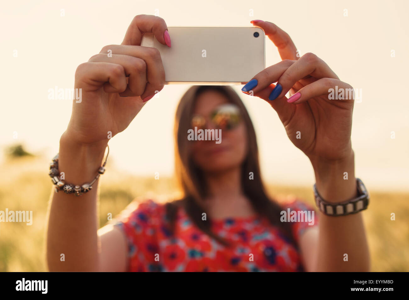Young woman closeup in red dress using mobile smart phone, summer outdoor Stock Photo Alamy