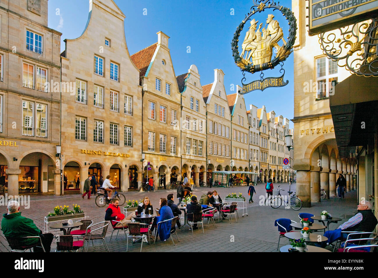 sign Stuhlmacher on front of the sandstone facades of the Prinzipalmarkt, people in the pavement cafe, Germany, North Rhine-Westphalia, Muensterland, Munster Stock Photo