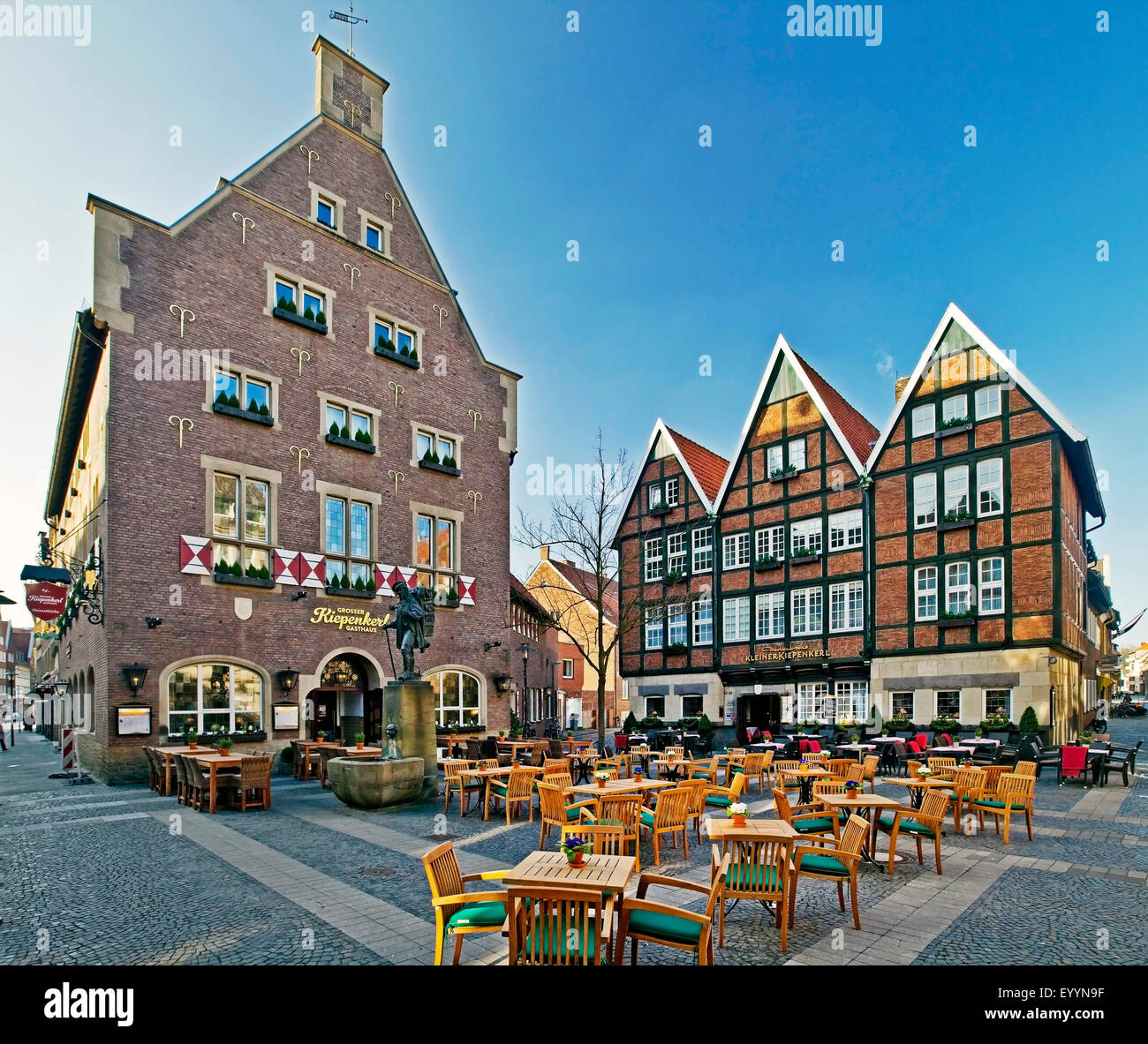 sidewalk restaurant and Kiepenkerl statue, Germany, North Rhine-Westphalia, Munster Stock Photo