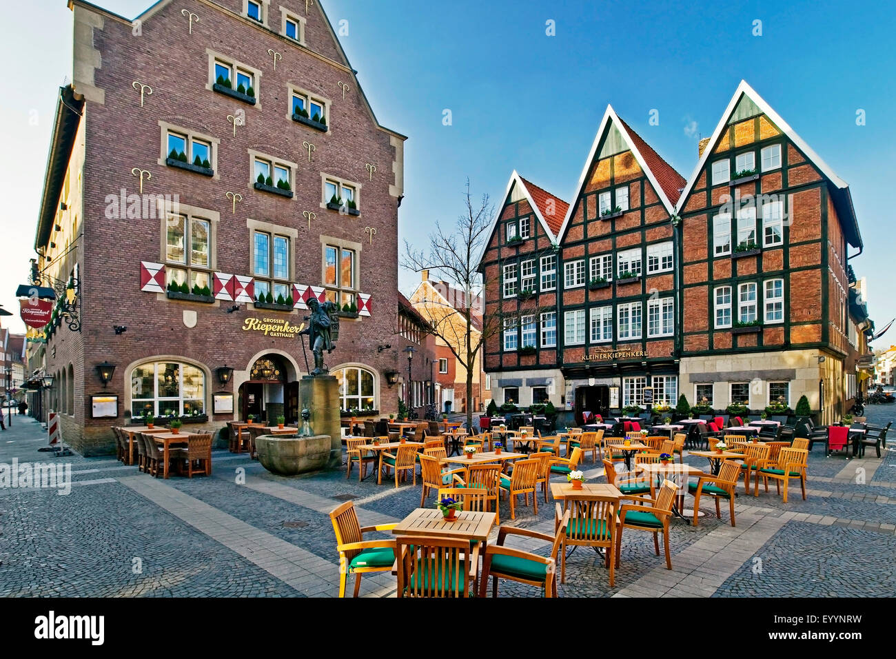 sidewalk restaurant and Kiepenkerl statue, Germany, North Rhine-Westphalia, Munster Stock Photo