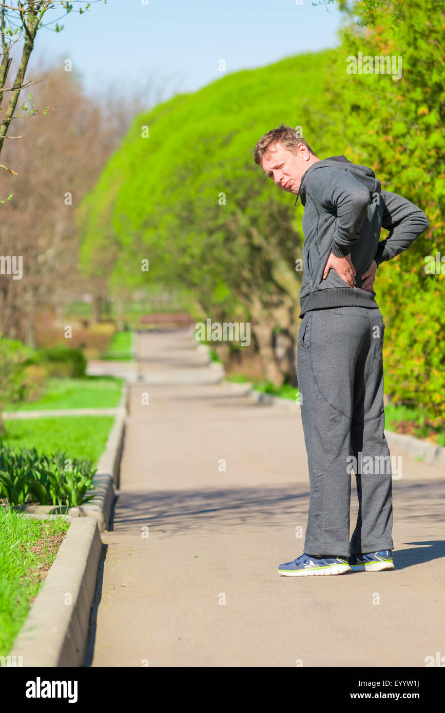 a man while jogging have begun back pain Stock Photo