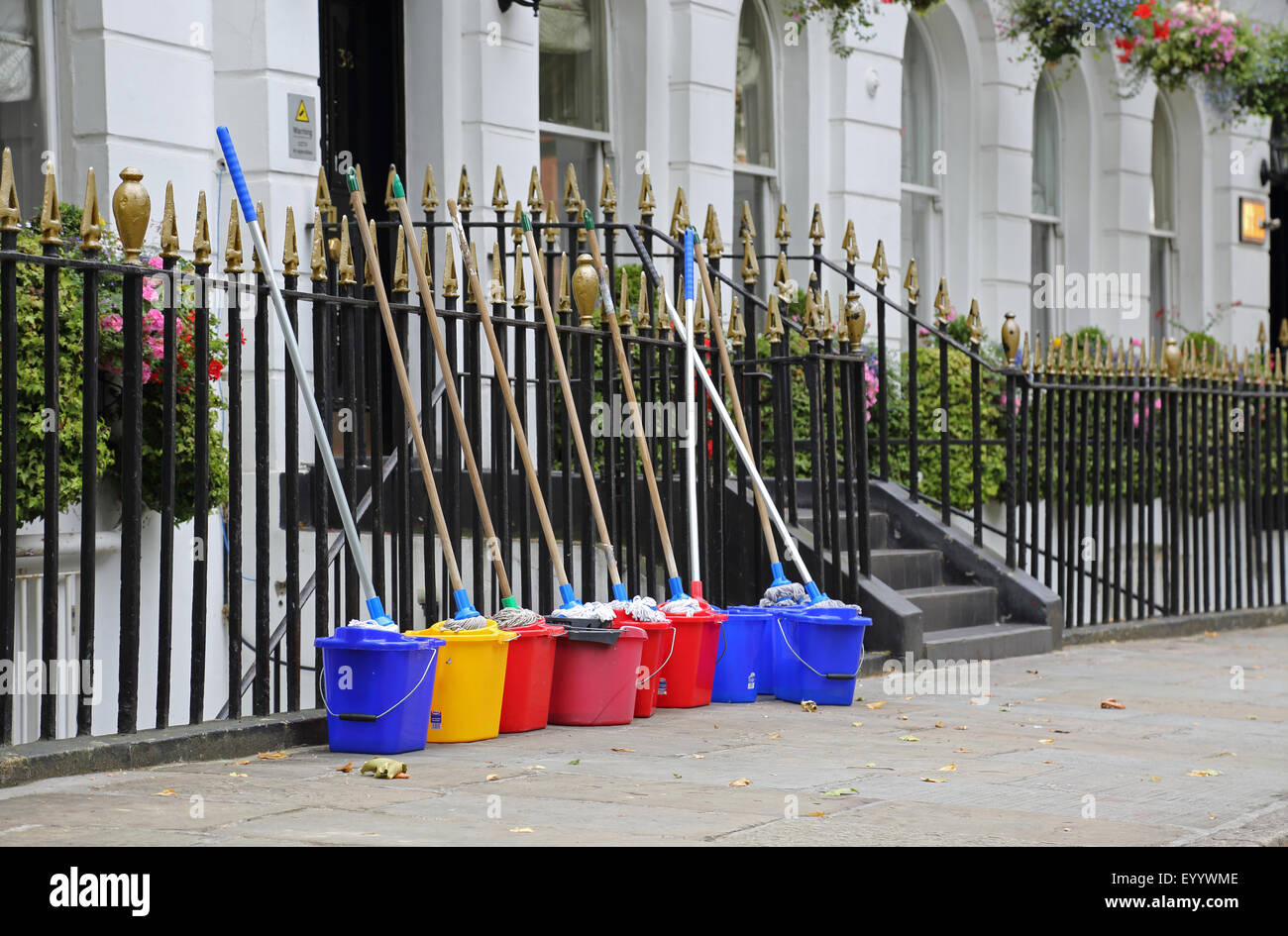 Contractors cleaning equipment lined up outside a prestigious