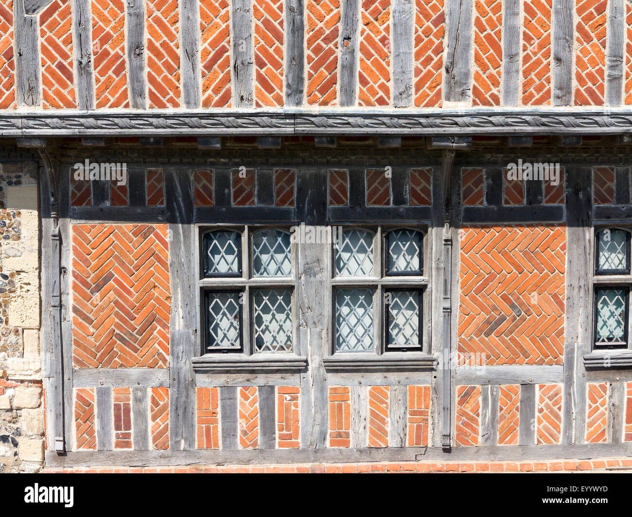 Detail of vernacular Norfolk architecture showing timber frame building with herringbone brick infill Stock Photo