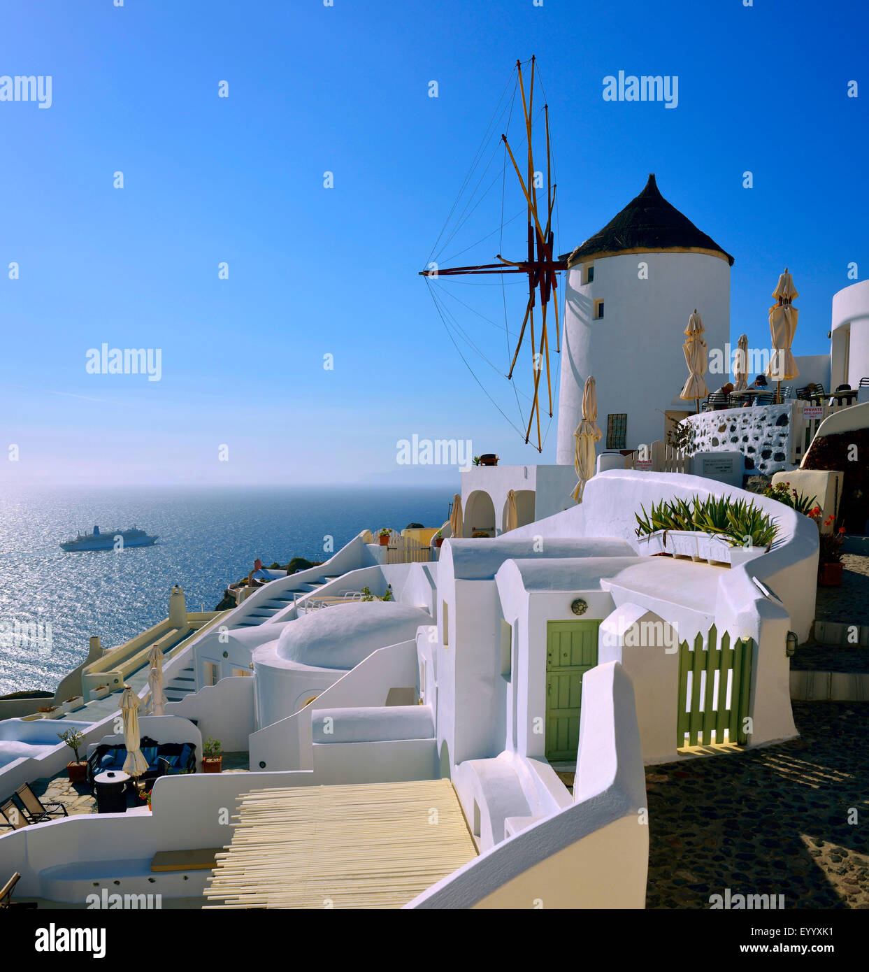 Luxurious hotels and windmill in the village of Oia, Greece, Cyclades, Santorin Stock Photo
