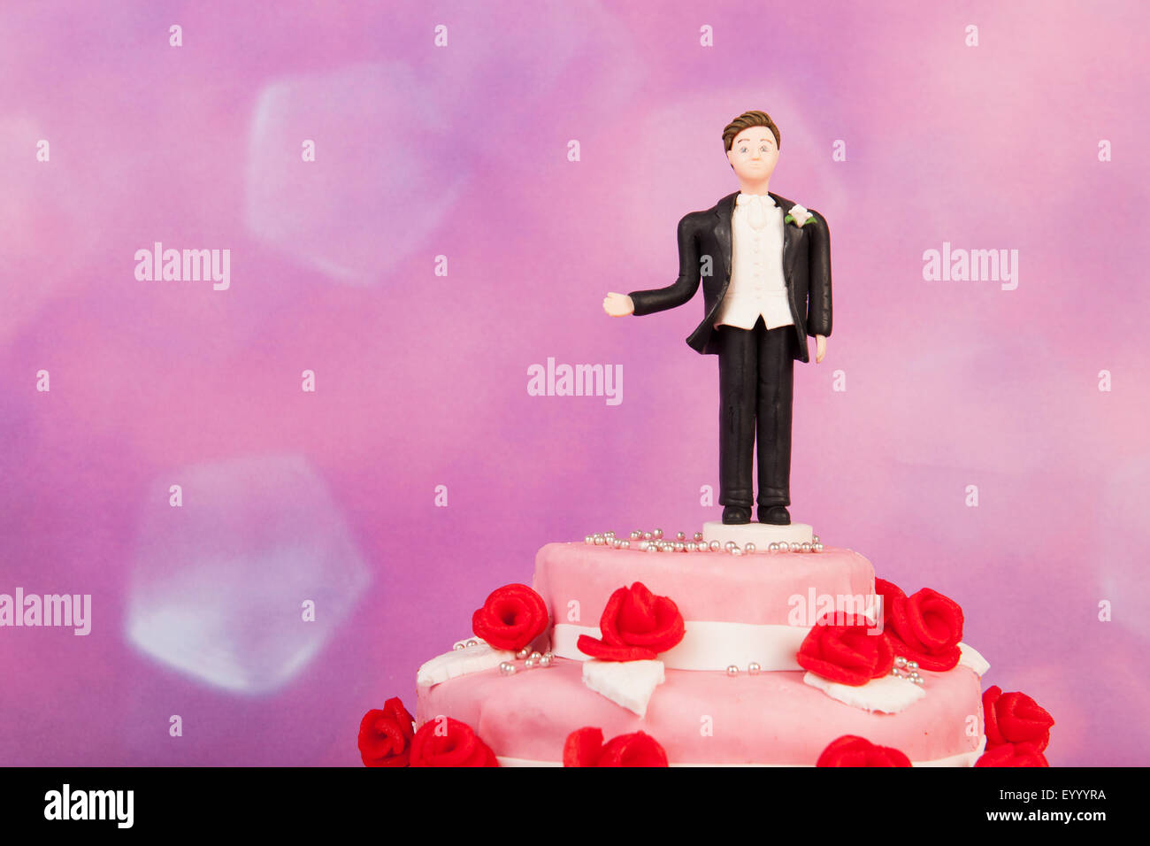 Figurine man alone at the wedding cake Stock Photo