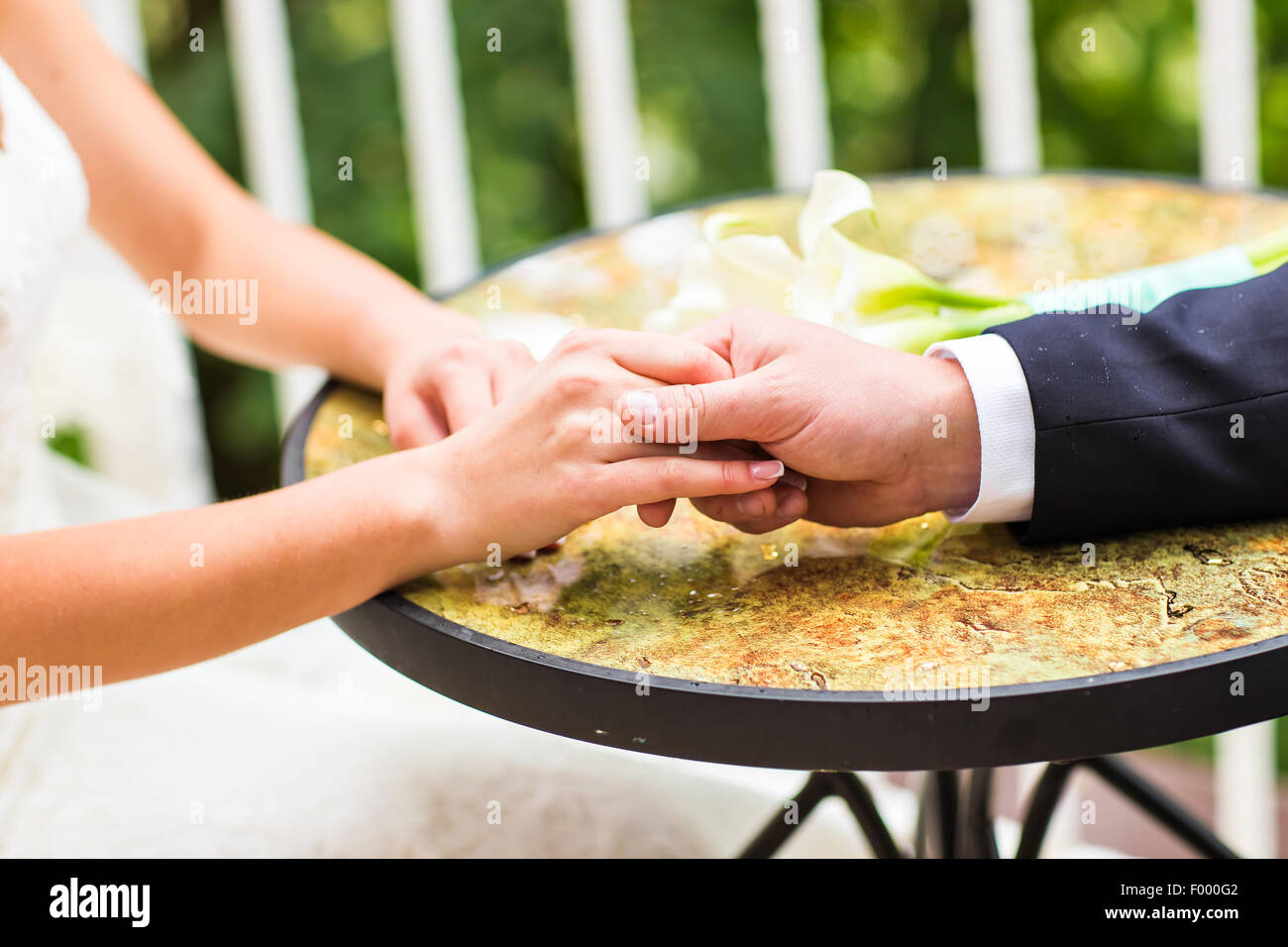 Wedding couple holding hands Stock Photo - Alamy