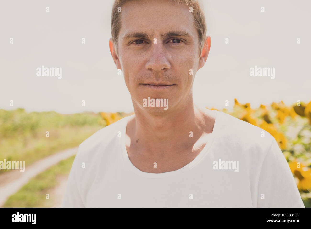 Portrait of casual man in white shirt, summertime outdoor Stock Photo