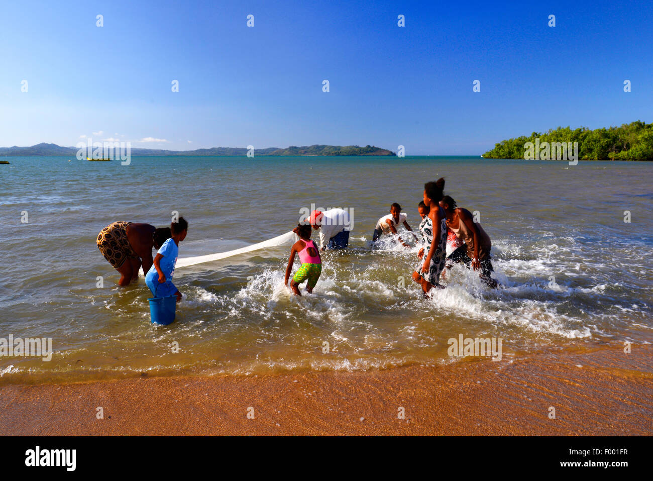 African women are fishing with a curtain, Madagascar, Nosy Be, Lokobe Reserva Stock Photo