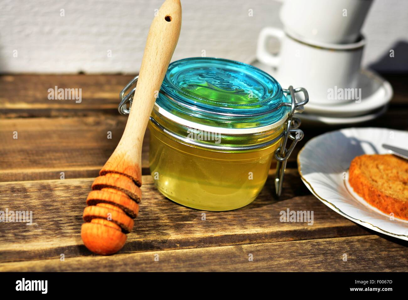 Stil life of honey, toast, cup and plate Stock Photo