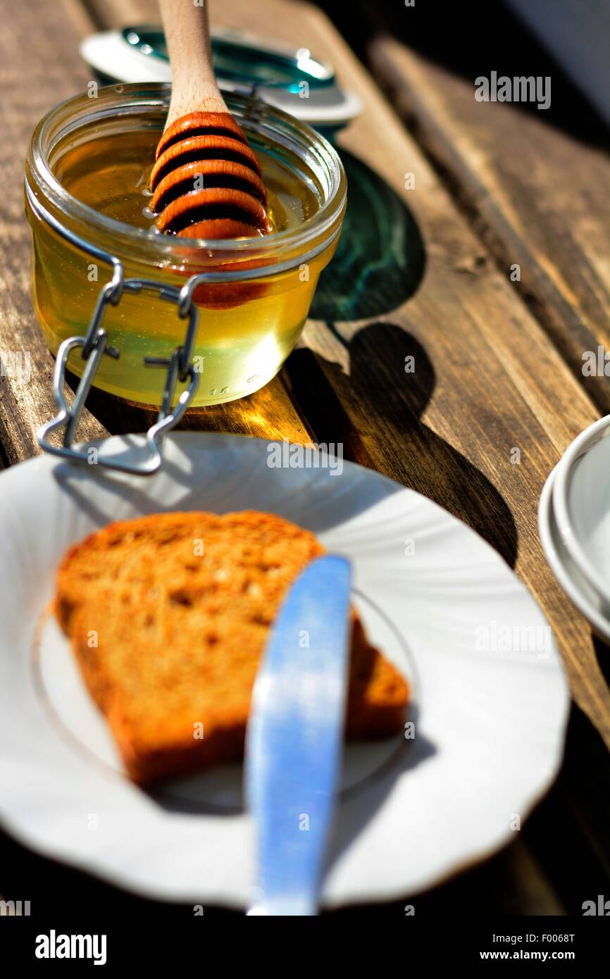 Stil life of honey, toast, cup and plate Stock Photo