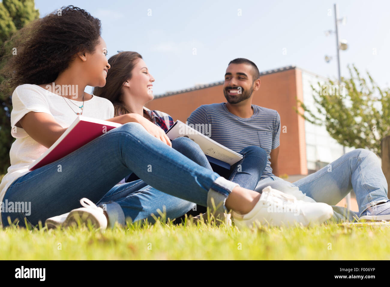 Students sitting on the grass at School Campus Stock Photo - Alamy