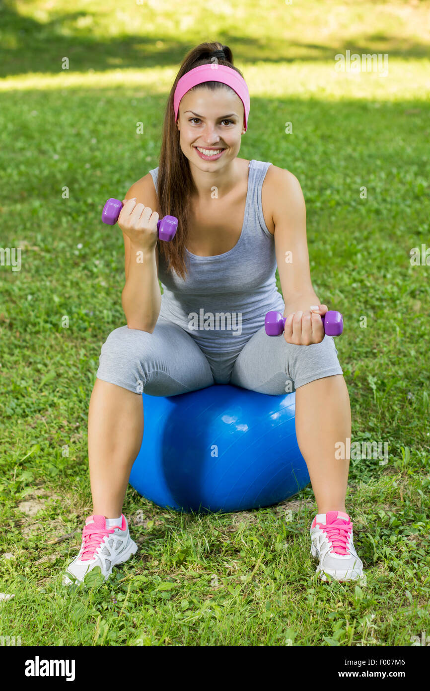 Attractive girl practicing pilates on hi-res stock photography and