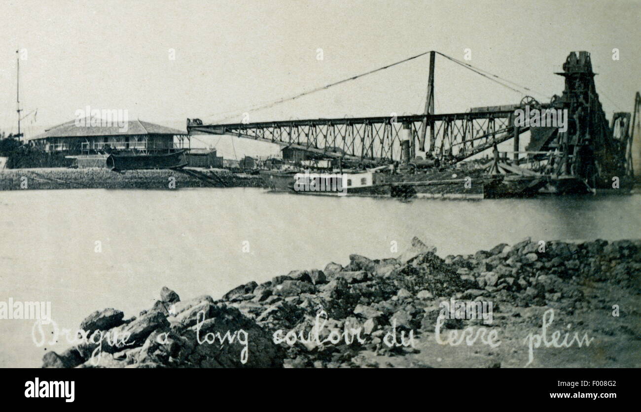 Suez, Egypt - 1870s - A dredger at work in the Suez Canal.  Taking 10 years to build, the Suez Canal was the brainchild of Frenchman Ferdinand De Lesseps, who became the president of the Canal Maritime de Suez (Suez Canal Company).  The official party lasted for 10 days.  An account by Thos. H. Reid in 1909: ÒThe opening ceremony was made a magnificent international function.  An opera house was built in Cairo at a cost of 60,000 sterling.  Verdi, the composer, wrote the Egyptian opera Aida for the occasion. Stock Photo