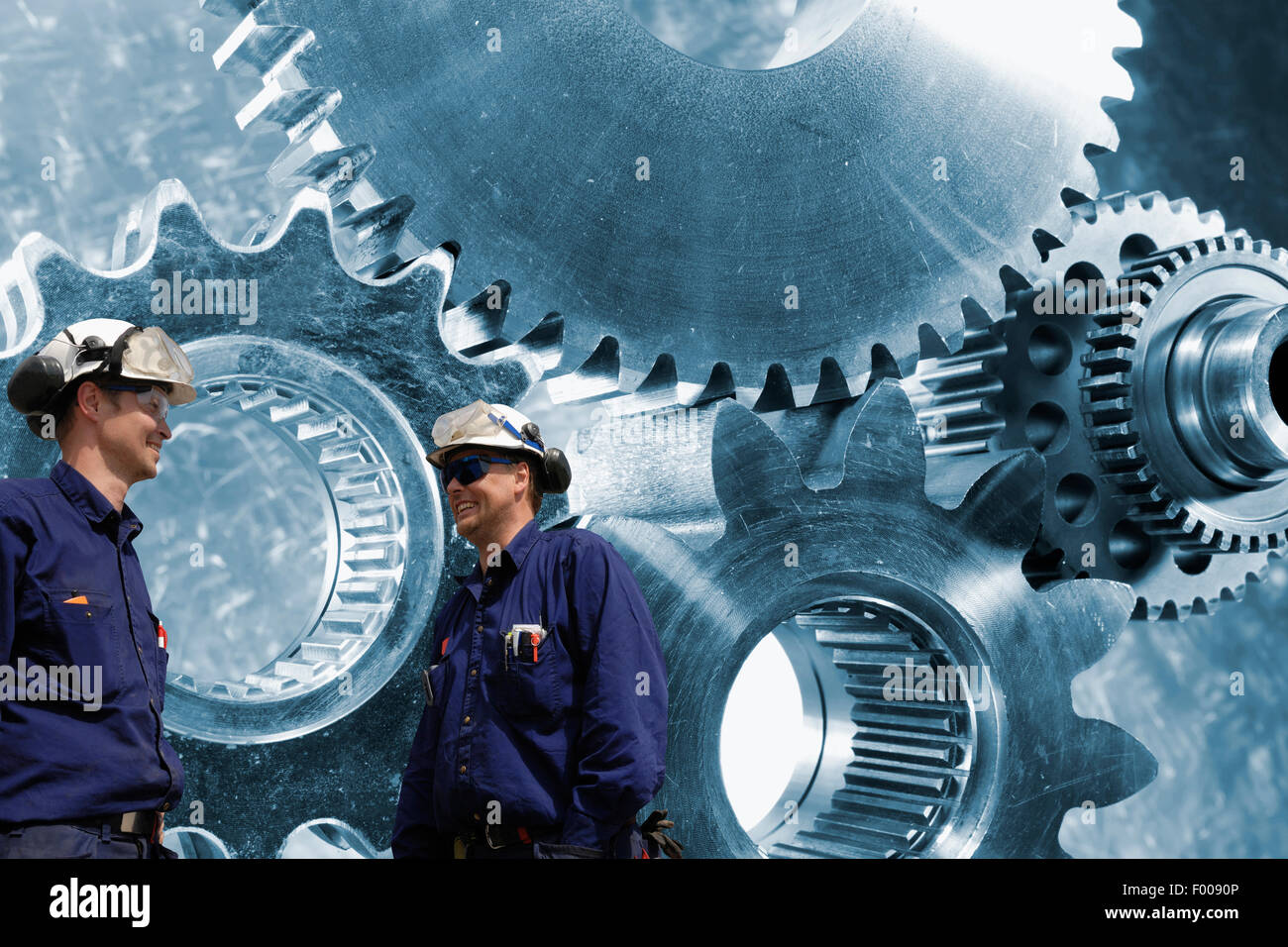 mechanics, workers with giant cogwheels machinery Stock Photo