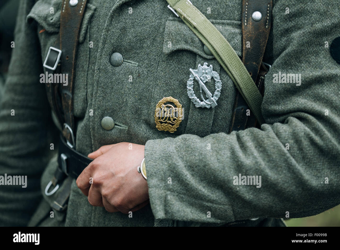Unidentified re-enactor dressed as German soldier. German military decoration on the uniform of a German soldier. Stock Photo