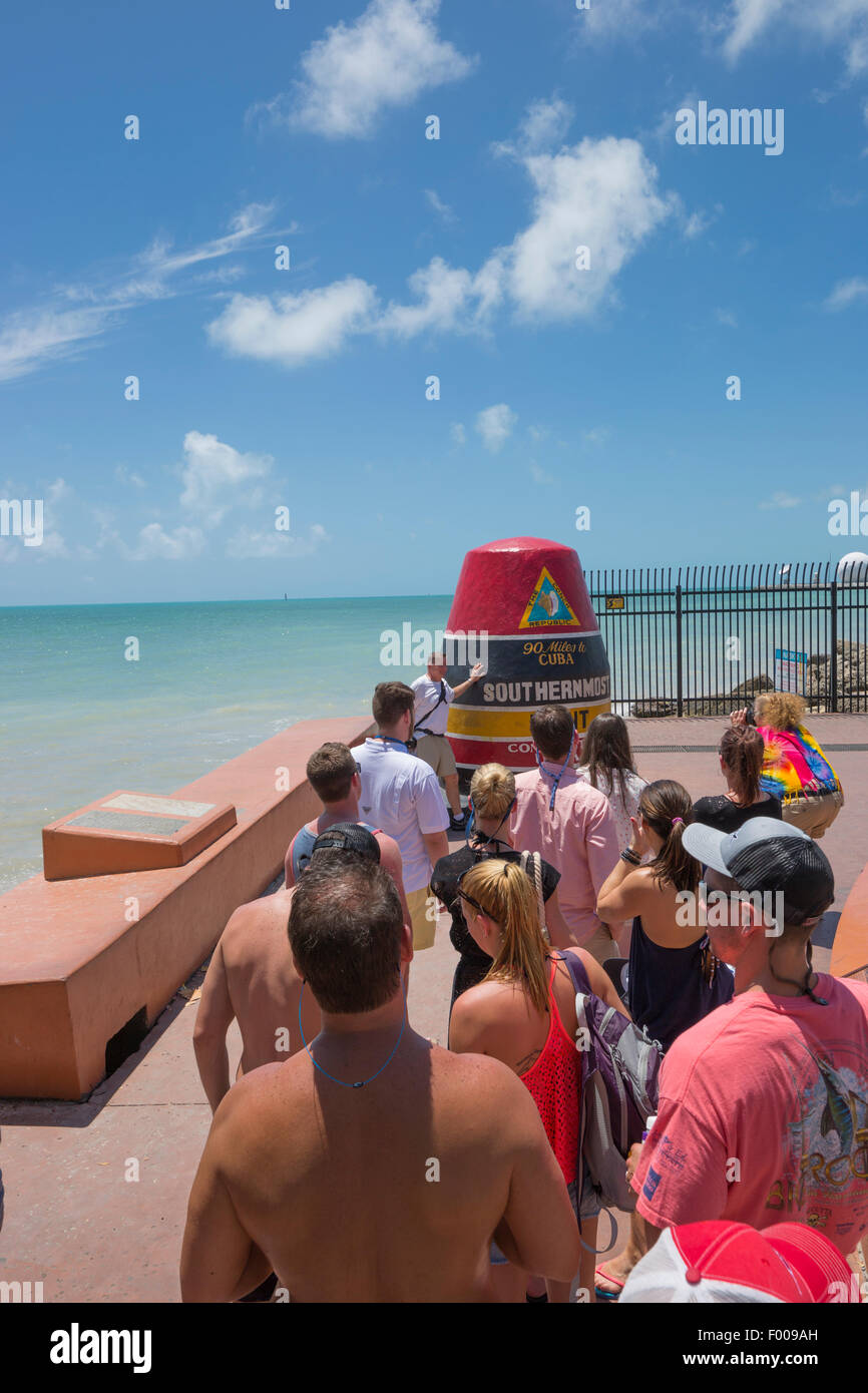 TOURISTS LINE UP IN QUEUE TO POSE BY  SOUTHERNMOST POINT IN CONTINENTAL UNITED STATES MONUMENT KEY WEST FLORIDA USA Stock Photo