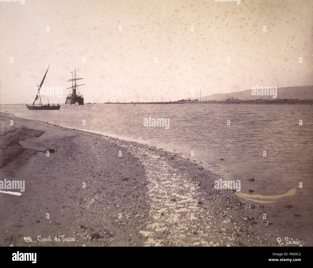 Southern Suez Canal, Egypt - 1870s - Taking 10 years to build, the Suez Canal was the brainchild of Frenchman Ferdinand De Lesseps, who became the president of the Canal Maritime de Suez (Suez Canal Company).  The official party lasted for 10 days.  An account by Thos. H. Reid in 1909: ÒThe opening ceremony was made a magnificent international function.  An opera house was built in Cairo at a cost of 60,000 sterling.  Verdi, the composer, wrote the Egyptian opera ÒAidaÓ for the occasion, and no composition is more popular during the Cairo season today when it is produced with all the splendour Stock Photo