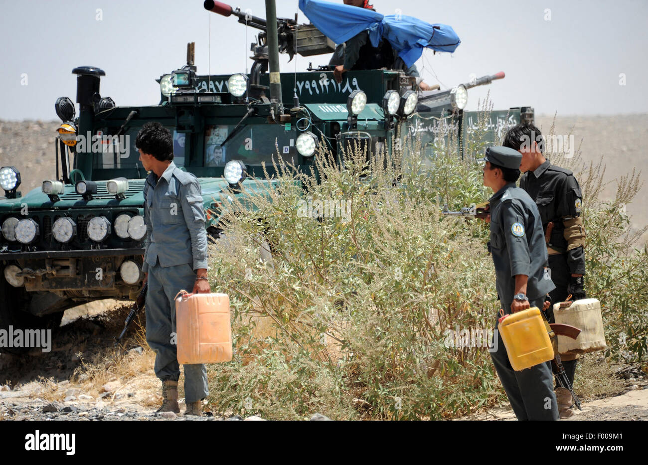 Kandahar. 5th Aug, 2015. Afghan police officers carry disposed explosive device and mines in Kandahar province in southern Afghanistan, Aug. 5, 2015. Some 1,592 Afghan civilians were killed as a result of armed conflicts and war in the first half of this year, a UN mission here said in its mid-year report released on Wednesday. Credit:  Sanaullah/Xinhua/Alamy Live News Stock Photo