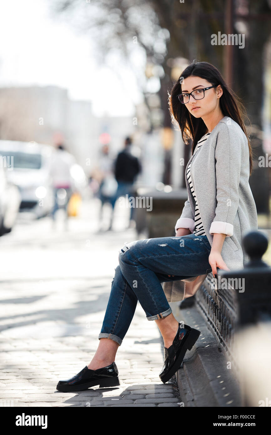 Beautiful model in a coat and glasses Stock Photo - Alamy