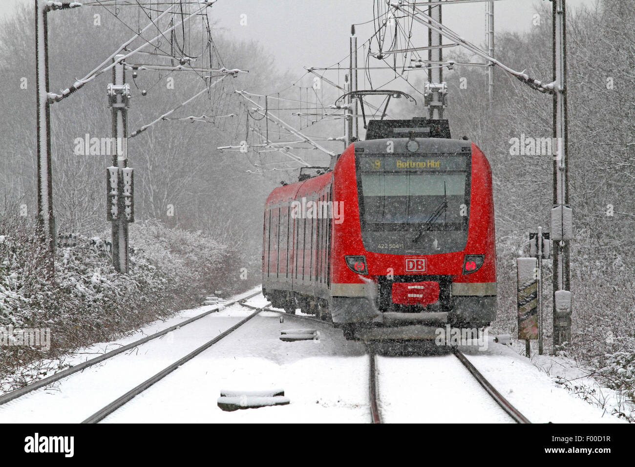 city train during snowfall, Germany Stock Photo