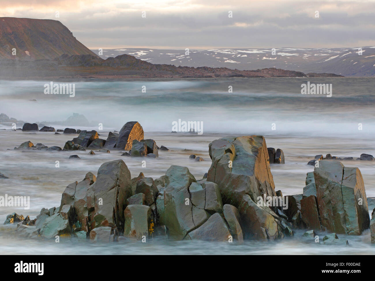 stormy coastline and snowy peaks, fjells along coast, Barentz sea, Norway, Varangerfjord Stock Photo