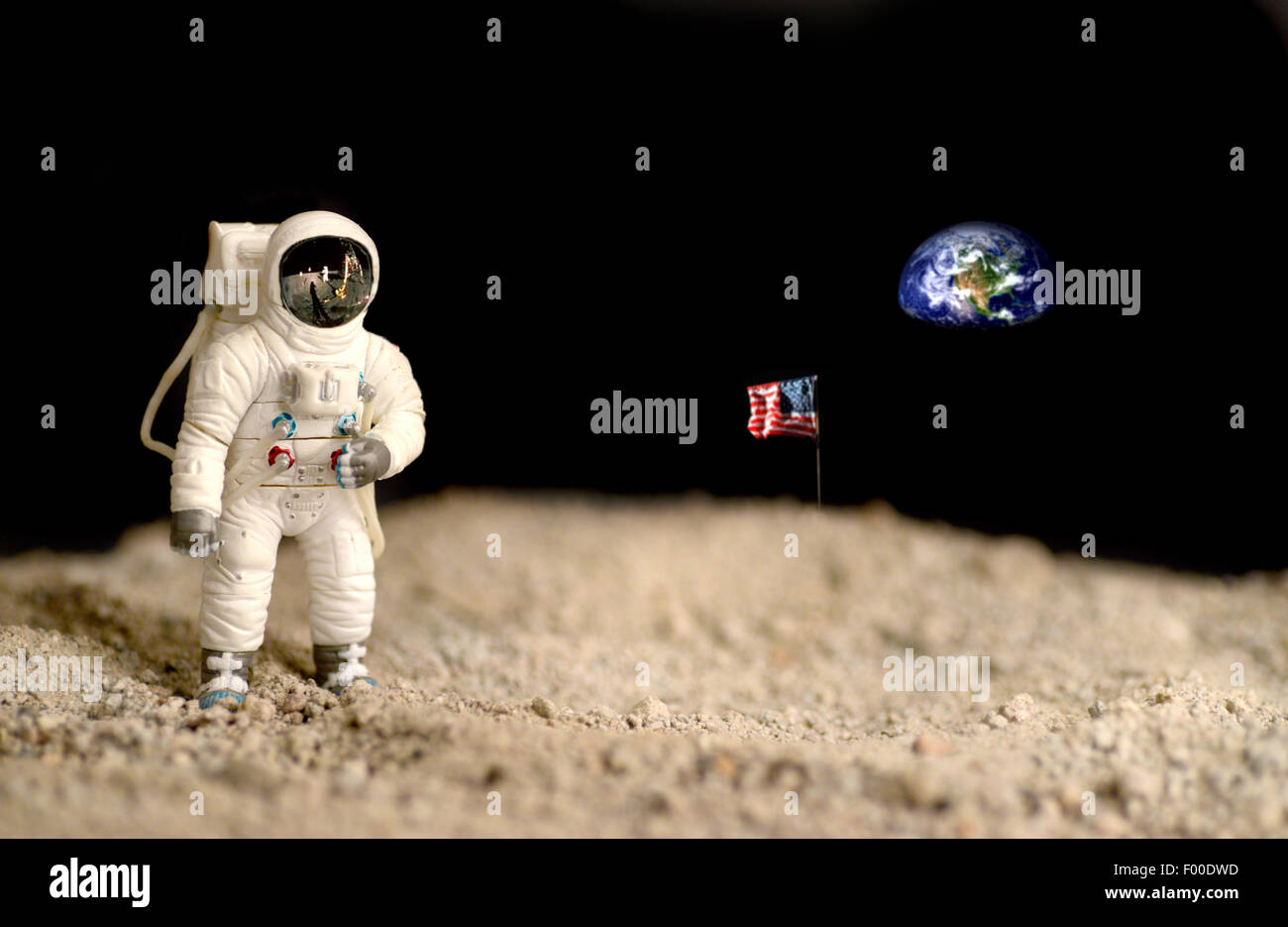 Astronaut on the moon with the earth and the american flag on the background, elements of this image furnished by NASA. Stock Photo