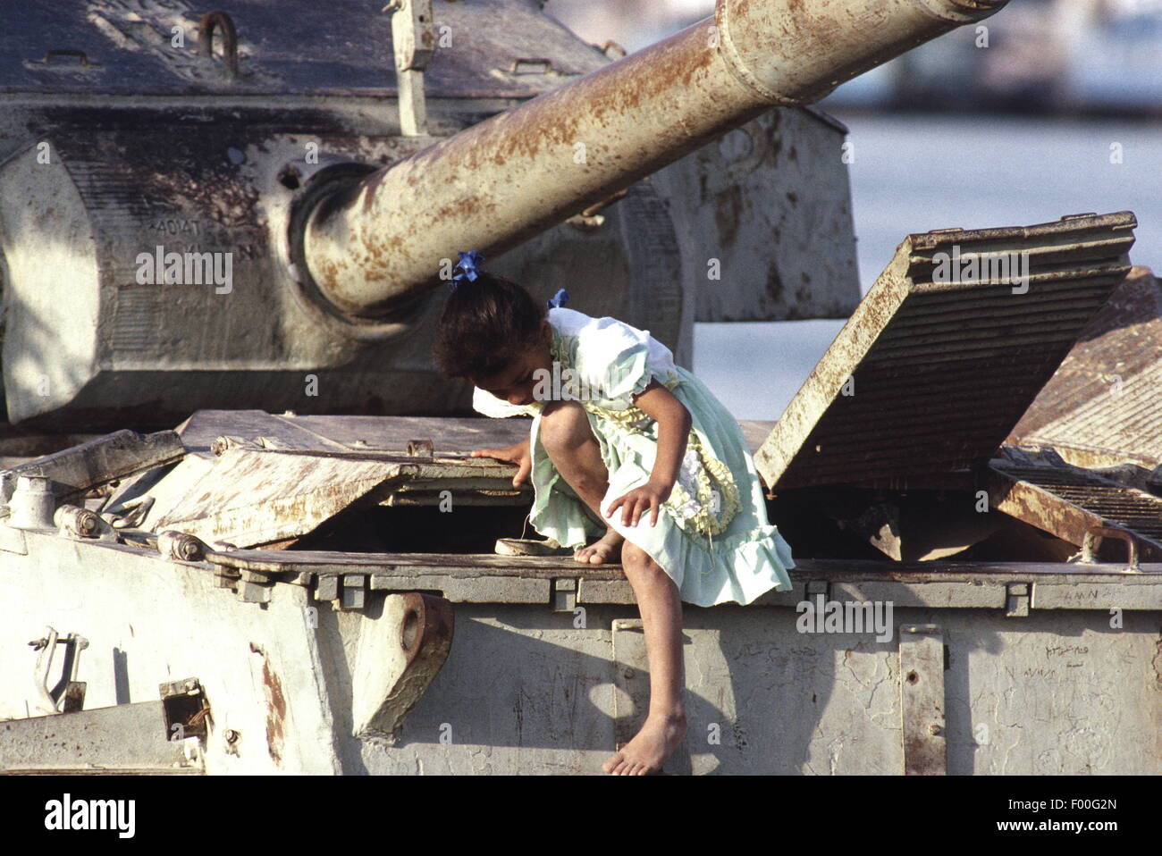 Suez Canal, Egypt - Egyptian children play on a ruined tank at the southern end of the Suez Canal, witness to wars past between Egypt and Israel. Stock Photo