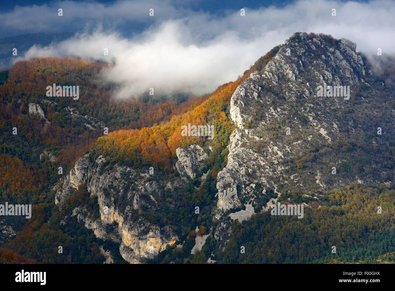 Mountain peaks and rocks in mist in autumn, France, Vercors National Park Stock Photo