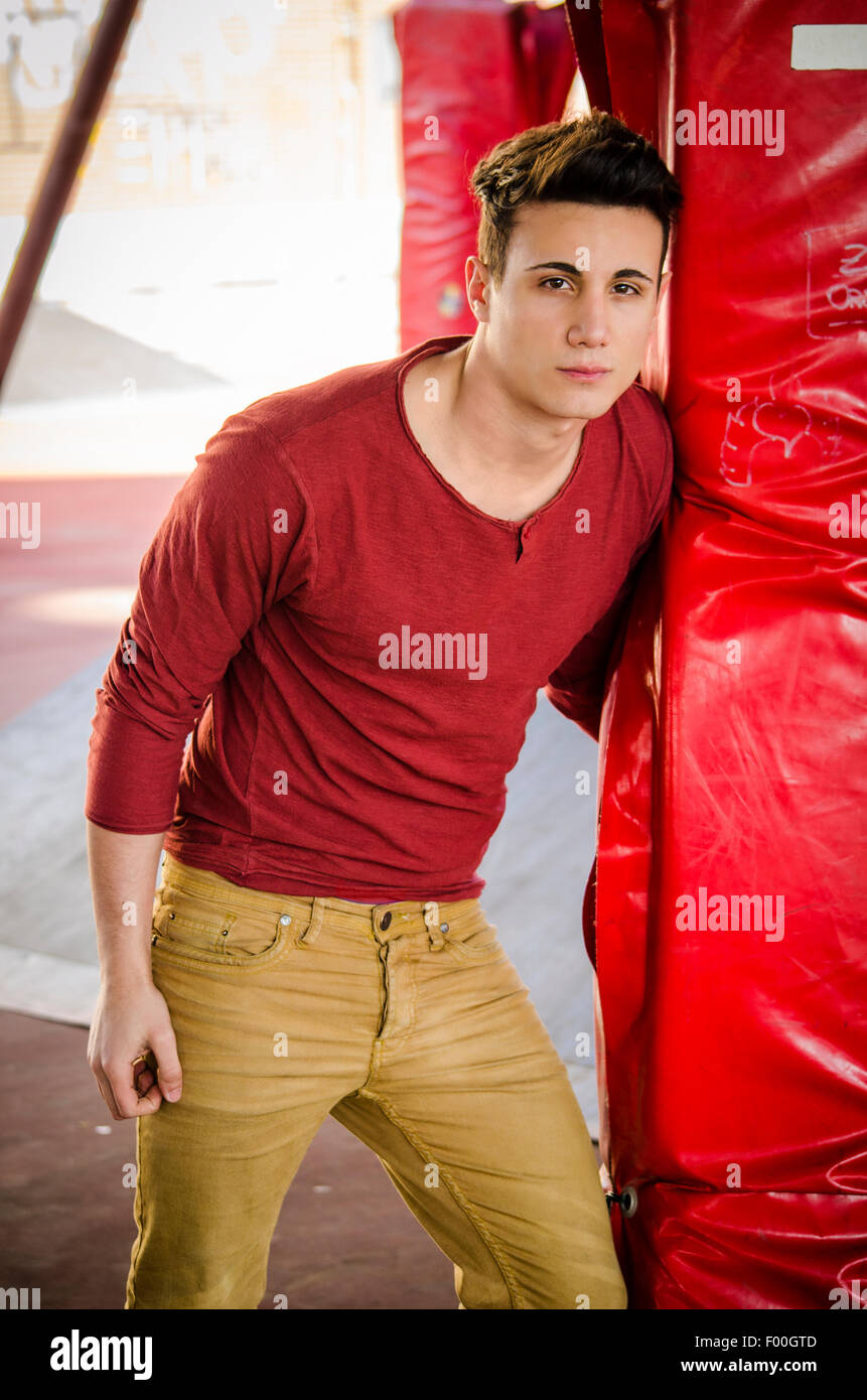 Attractive young man in urban setting looking at camera Stock Photo